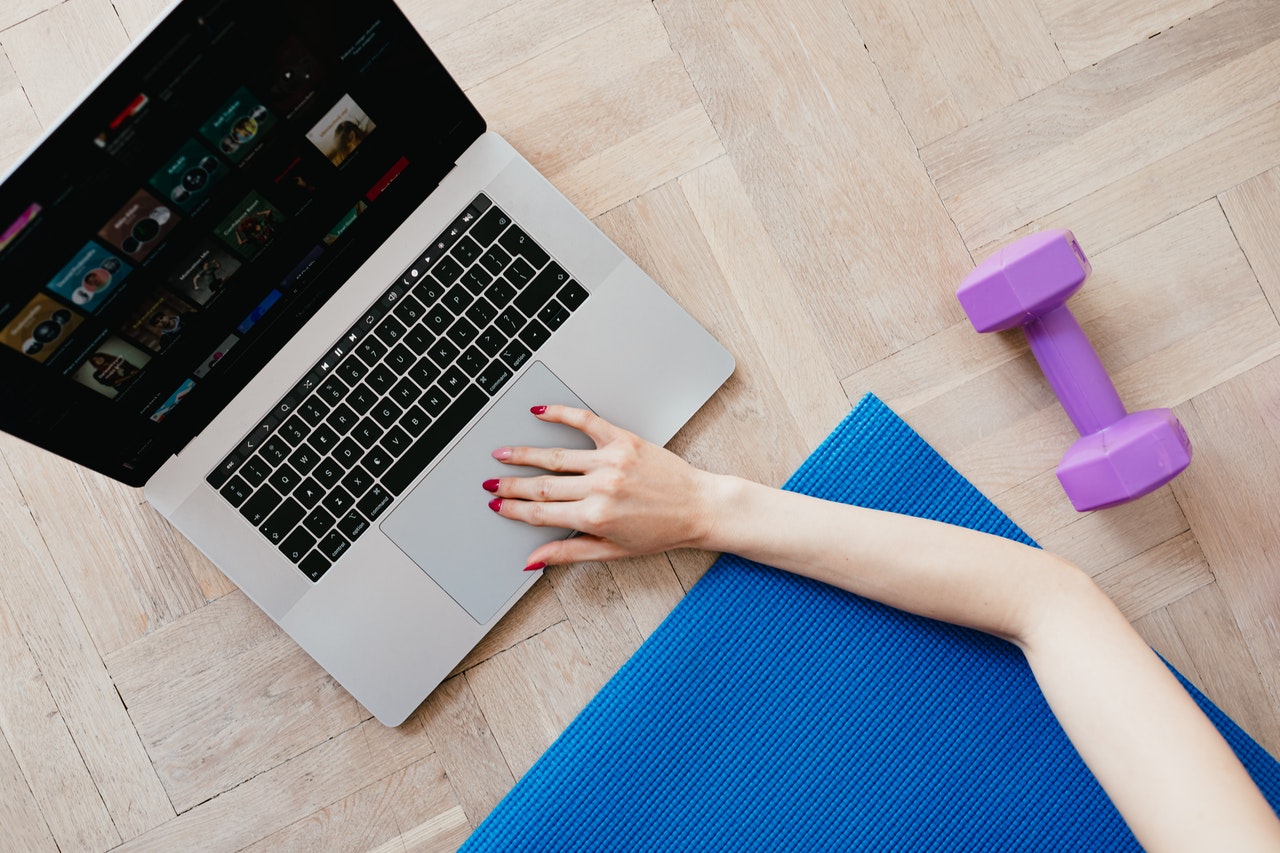 laptop and dumbbell for virtual workout 